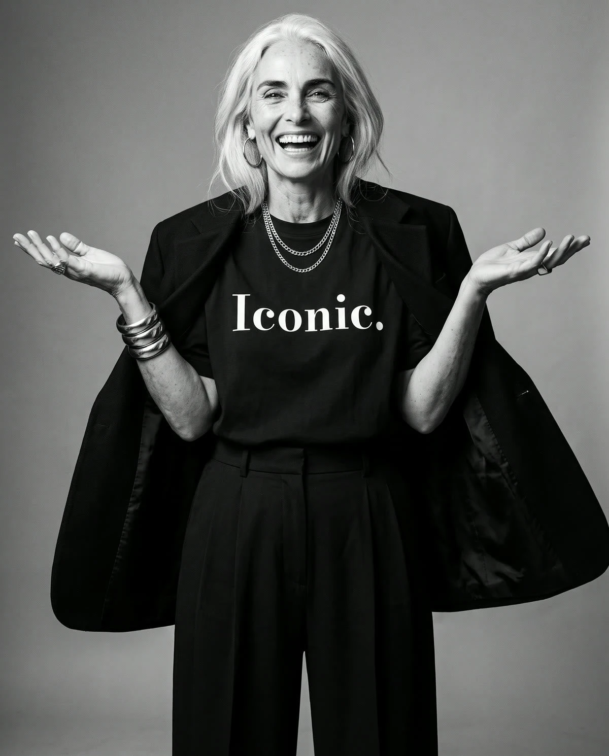 Tee Cartel Iconic tee campaign image, with the model laughing and opening her arms