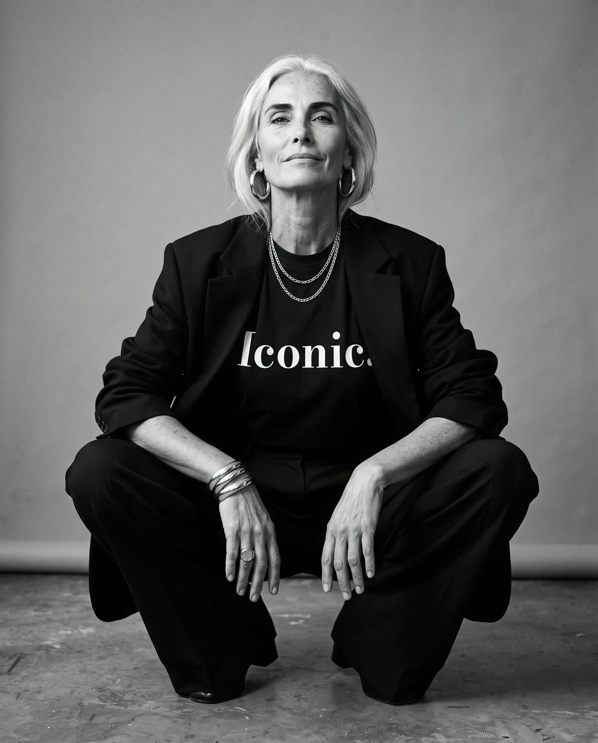 Tee Cartel Iconic tee campaign image, with the model crouched in a full-length pose